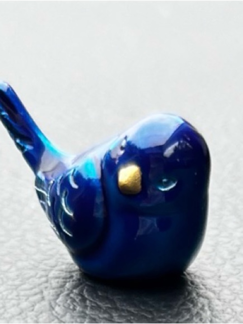 Little blue bird figurine. 1” Blue Ceramic Bird Toy with Gold Accent.